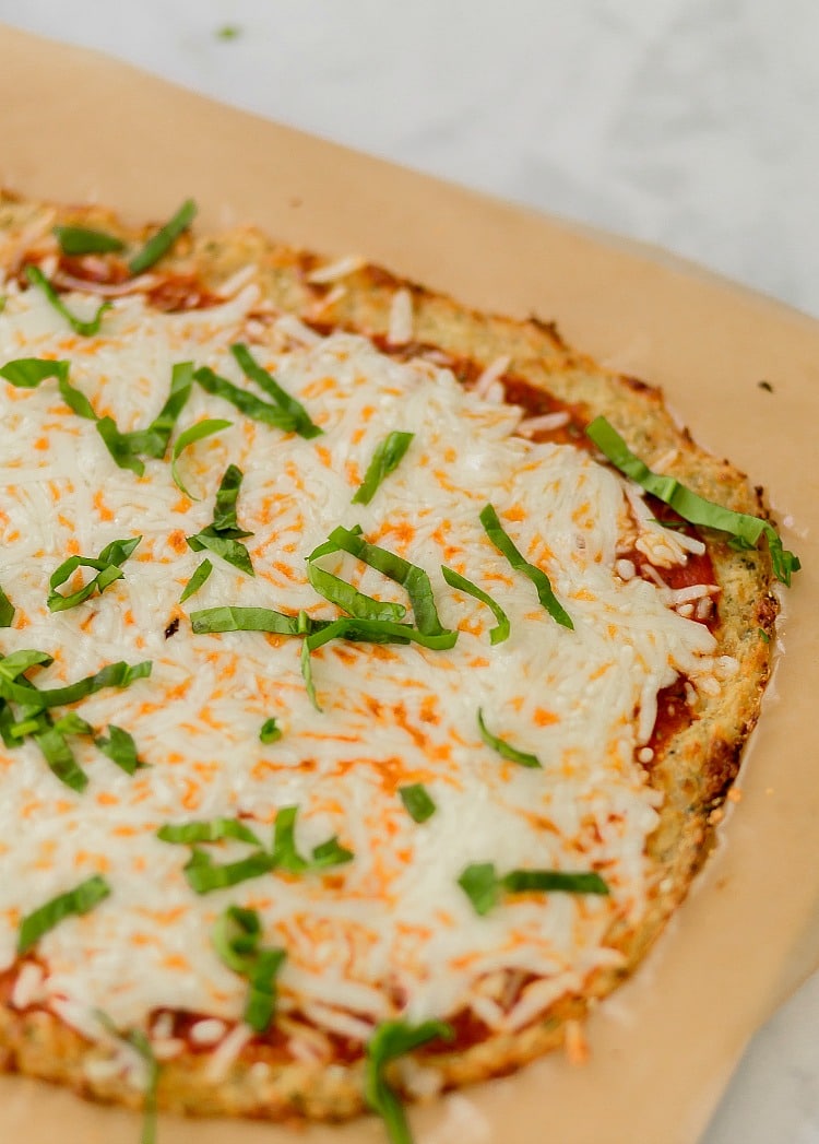 This keto friendly Cauliflower Pizza Crust is crispy, delicious, low-carb, and super easy to make. Top with your favorite sauce and veggies & it'll be a hit