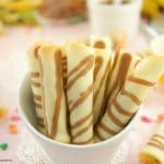 These crispy Tuile Rolls aka Wafer rolls or Barquillos are buttery, sweet and easy to make. Perfect to serve with ice cream and desserts white bowl and striped tuiles