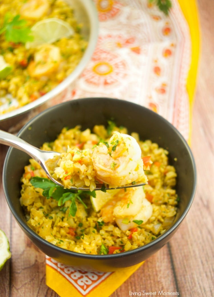 This delicious Curried Riced Cauliflower recipe with shrimp is low carb, paleo and keto friendly. Quick dinner idea, showing a black bowl with a fork