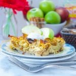 This delicious Apple Noodle Kugel recipe is both sweet and savory. A slice of kugel with apples and a shiny fork