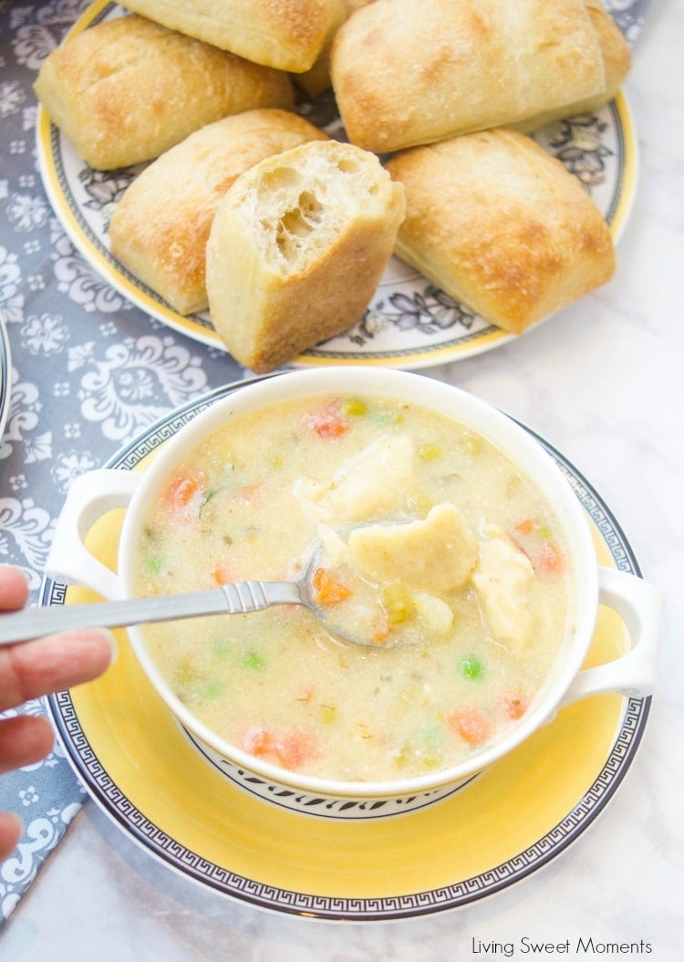 This creamy Potato Dumpling Soup recipe is the perfect hearty vegetarian soup for winter. Enjoy homemade dumplings. Closeup of the soup shown the dumplings and colorful veggies