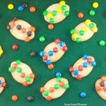 These fun M&M Football Cookies are the perfect kid friendly treat for the Superbowl, tailgating parties, sporting events and more. Use your favorite team colors to decorate