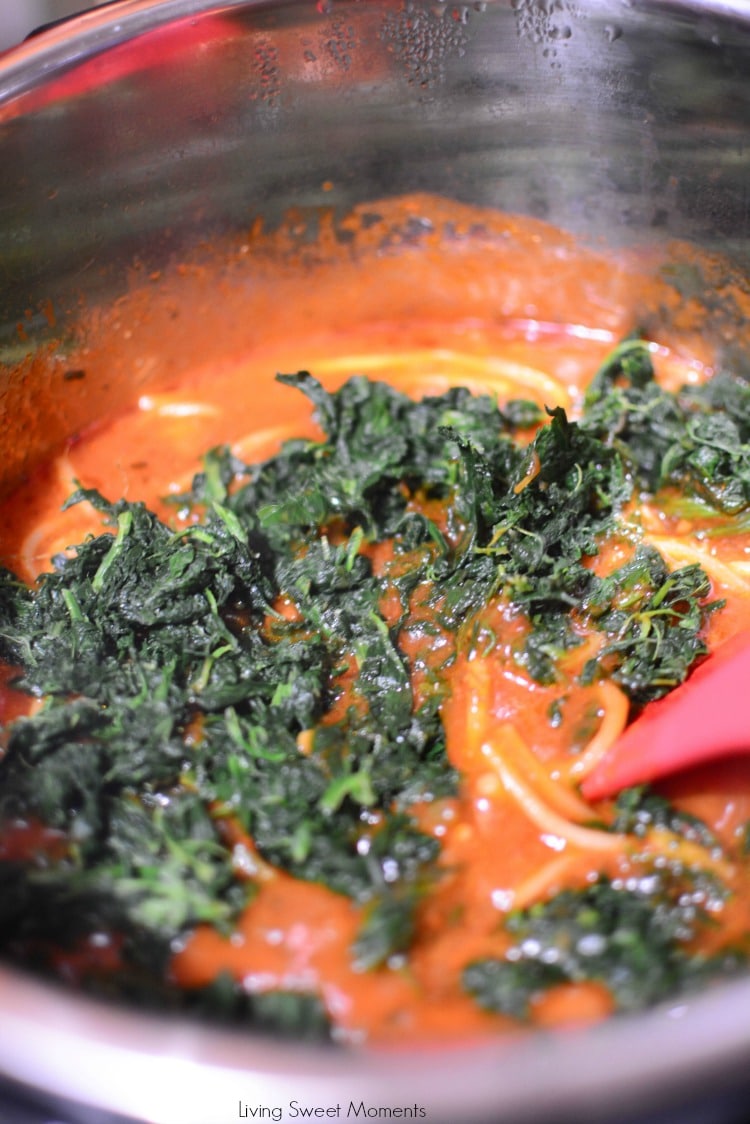 This quick Instant Pot Pasta Recipe is made with sausage and spinach. A image showing the tomato sauce with spinach