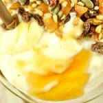 This super Easy Instant Pot Yogurt recipe a closeup of yogurt topped with trail mix and honey