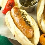 Juicy and delicious grilled Choripan, aka Chorizo Hot Dogs served with chimichurri sauce. The perfect food for parties and celebrations