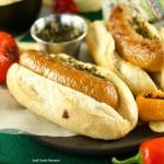 Juicy and delicious grilled Choripan, aka Chorizo Hot Dogs served with chimichurri sauce. The perfect food for parties and celebrations