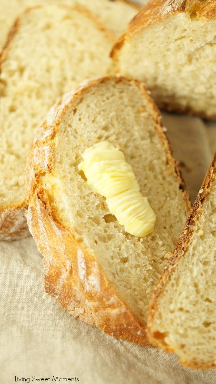 This crusty and delicious Instant Pot Sourdough Bread shows slices of bread with a little dab of butter