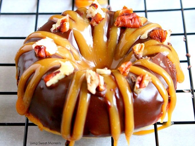 closeup of decadent Baked Turtle Donuts are are glazed with chocolate, sprinkled with toasted pecans and drizzled with sweet caramel. An irresistible dessert that tastes better than the Turtles candy bar