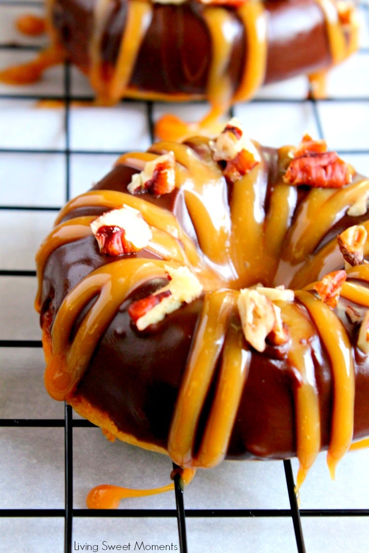 These decadent Baked Turtle Donuts are are glazed with chocolate, sprinkled with toasted pecans and drizzled with sweet caramel. An irresistible dessert that tastes better than the Turtles candy bar