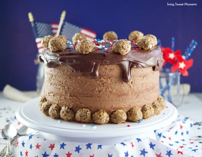 This colossal Peanut Butter Chocolate Cake recipe is made from scratch and is garnished with peanut butter chocolate truffles rolled in peanut butter & cocoa pebbles cereal