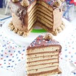 This colossal Peanut Butter Chocolate Cake recipe is made from scratch and is garnished with peanut butter truffles. Showing the cake and a slice