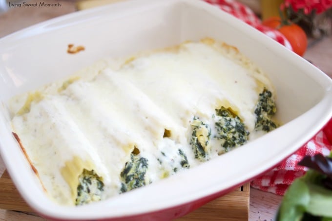 Enjoy a delicious vegetarian comfort dinner under an hour with this cheesy Spinach Artichoke Manicotti baked in a rich Bechamel sauce showing in a red square pyrex