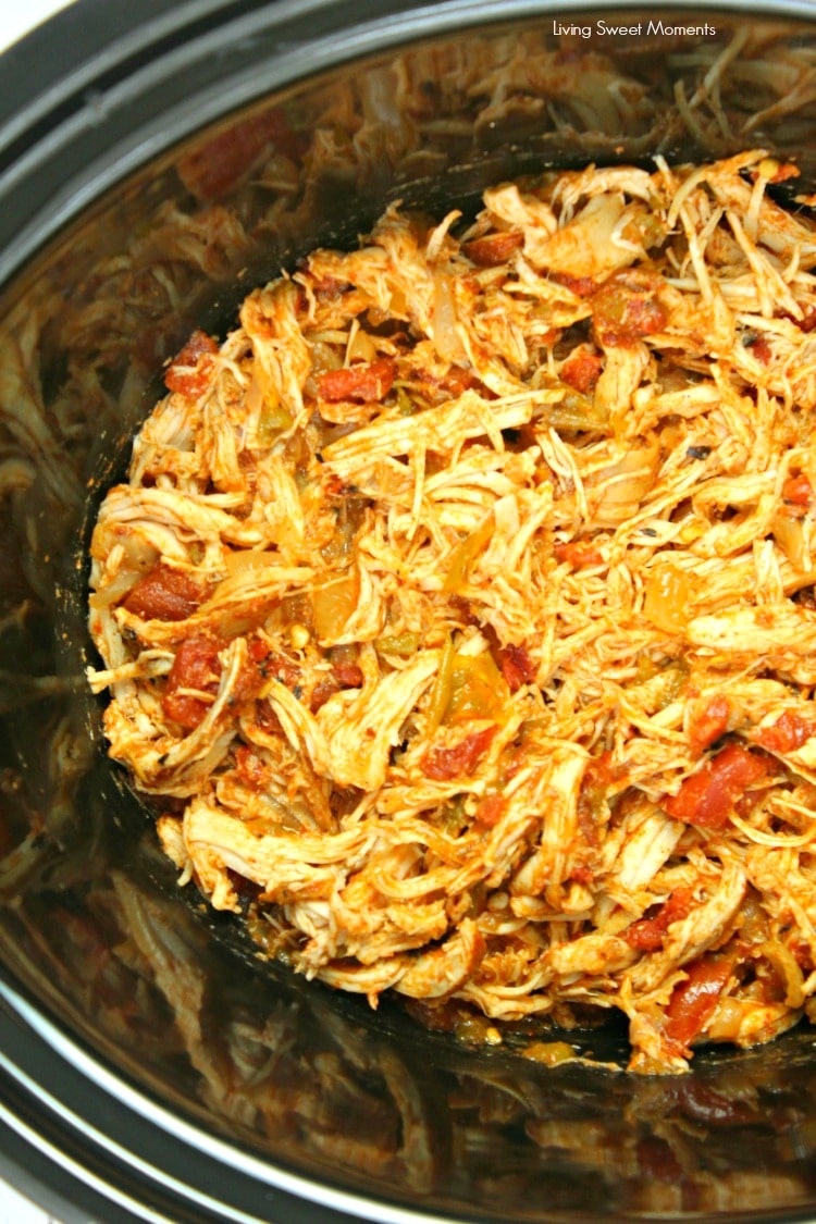 You won't believe how easy these Slow Cooker Shredded Chicken Tacos are to make. Shown the chicken in the slow cooker