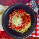 Come home to a delicious and comforting meal. This hearty Slow Cooker Sausage Puttanesca is served with zoodles. The perfect low-carb weeknight dinner idea.