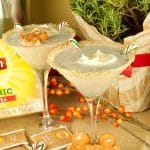 Get in the Holiday spirit with this creamy and flavorful Chai Tea Eggnog Cocktail served on a martini glass and garnished with fresh whipped cream.