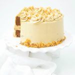 This delicious Butterfinger Cake Recipe dessert is made from scratch and features a moist chocolate cake with peanut butter frosting and butterfingers.