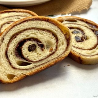 Cinnamon Raisin Sourdough Bread with a gooey cinnamon-sugar swirl and juicy raisins. Easy overnight method, timeline, tools, variations + fix