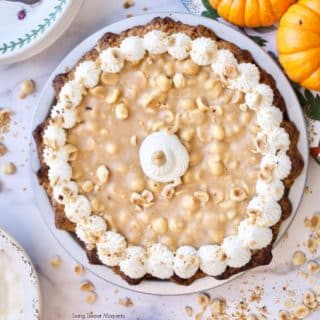 Elevate your Thanksgiving table with this delicious Hazelnut Praline Pumpkin Pie served on a flaky homemade crust 