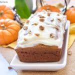 This delicious and moist pumpkin loaf recipe is topped with tangy cream cheese frosting and crystallized ginger pieces. It's perfect for breakfast, snack, or dessert! 