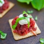 A delicious an easy appetizer! These Roasted Beet and Goat Cheese Crackers are garnished with fresh basil and balsamic vinegar reduction.