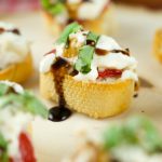 Roasted Red Pepper Burrata Crostini - crispy baguette slices are topped with roasted red peppers, creamy burrata, basil and a splash of balsamic glaze.