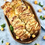 Soft, garlicky, cheesy sourdough pull-apart bread with golden layers, easy, cozy, and perfect for sharing or pairing with soups.