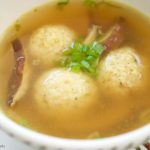 This Asian style Matzo Ball Soup recipe is made with a flavorful ginger scallion broth and shiitake mushrooms. Perfect for your modern Passover Seder menu.