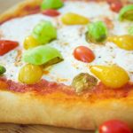 This delicious burrata pizza recipe is made with homemade pizza dough and is topped with sauce, summer tomatoes, and burrata cheese. Great for entertaining!