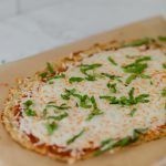 This keto friendly Cauliflower Pizza Crust is crispy, delicious, low-carb, and super easy to make. Top with your favorite sauce and veggies & it'll be a hit