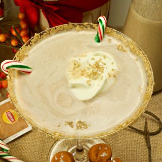 Get in the Holiday spirit with this creamy and flavorful Chai Tea Eggnog Cocktail served on a martini glass and garnished with fresh whipped cream.
