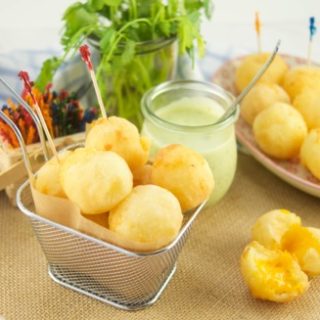 These amazing Cheese Stuffed Yuca Balls are crispy, delicate, and so cheesy! Served with a cilantro aioli. Perfect as bite-size appetizers for entertaining.