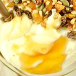 This super Easy Instant Pot Yogurt recipe a closeup of yogurt topped with trail mix and honey