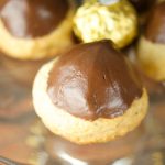 This Ferrero stuffed hazelnut cookies are topped with melted chocolate. The perfect crispy cookie recipe that will wow a crowd. Best dessert ever! Yum