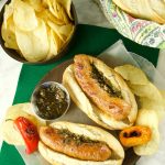 Juicy and delicious grilled Choripan, aka Chorizo Hot Dogs served with chimichurri sauce. The perfect food for parties and celebrations