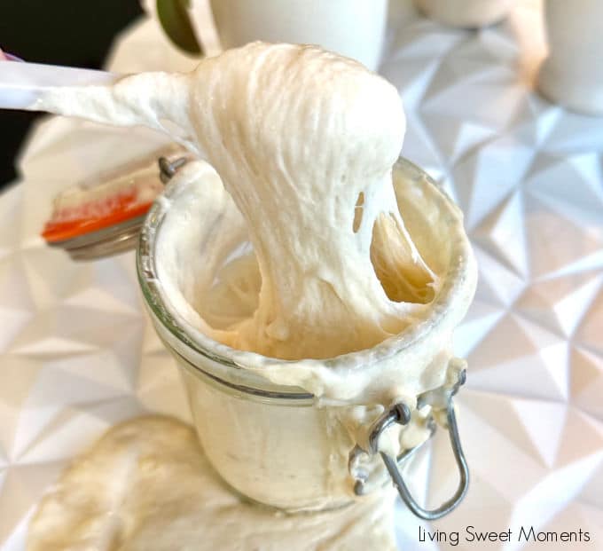 Stretchy, bubbly sourdough starter lifting from a jar