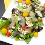 This tasty maple Roasted Peach Salad recipe is served with greens, tomatoes, almonds, parmesan and almonds, then tossed with a tangy maple vinaigrette.
