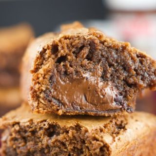Nutella Stuffed Brownies - the best fudgey brownies recipe filled with an ooey gooey center of Nutella. The perfect chocolate dessert for any occasion. More on www.livingsweetmoments.com