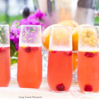 Orange raspberry sparkling wine cocktail: the ultimate summer cocktail! Combine cointreau with raspberry sorbet, fresh raspberries in a bubbly delicious drink.