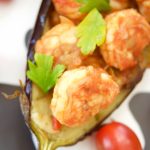 This delicious Shrimp Stuffed Eggplant Recipe is easy to make and is perfect for a nice weeknight dinner idea. The filling is inspired by Italian Caponata
