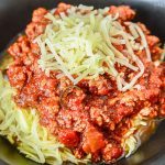 Come home to a delicious and comforting meal. This hearty Slow Cooker Sausage Puttanesca is served with zoodles. The perfect low-carb weeknight dinner idea.