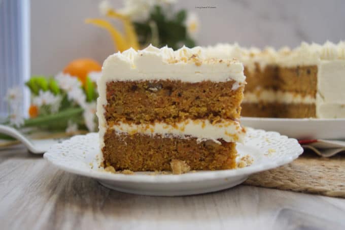 This stunning spiced Orange Ginger Carrot Cake is moist, tender, and delicious. Covered with cream cheese frosting. Have a slice!