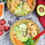 This delicious spicy shrimp poke bowl recipe is served with hot sushi rice, spicy mayo, avocados, radishes, and carrots. A quick weeknight dinner idea